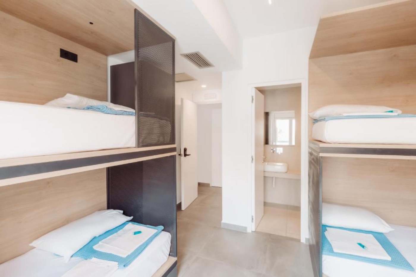 A shared room at Athens Backpackers with bunk beds and lockers.